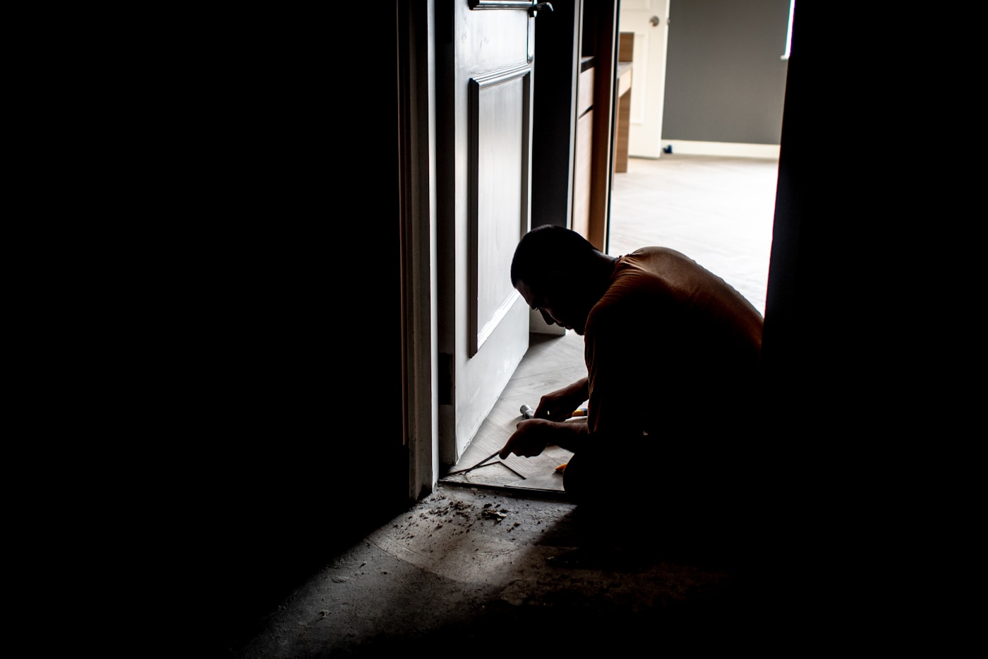 Drywall contractor working on interior wall repair at a Grand Rapids job site