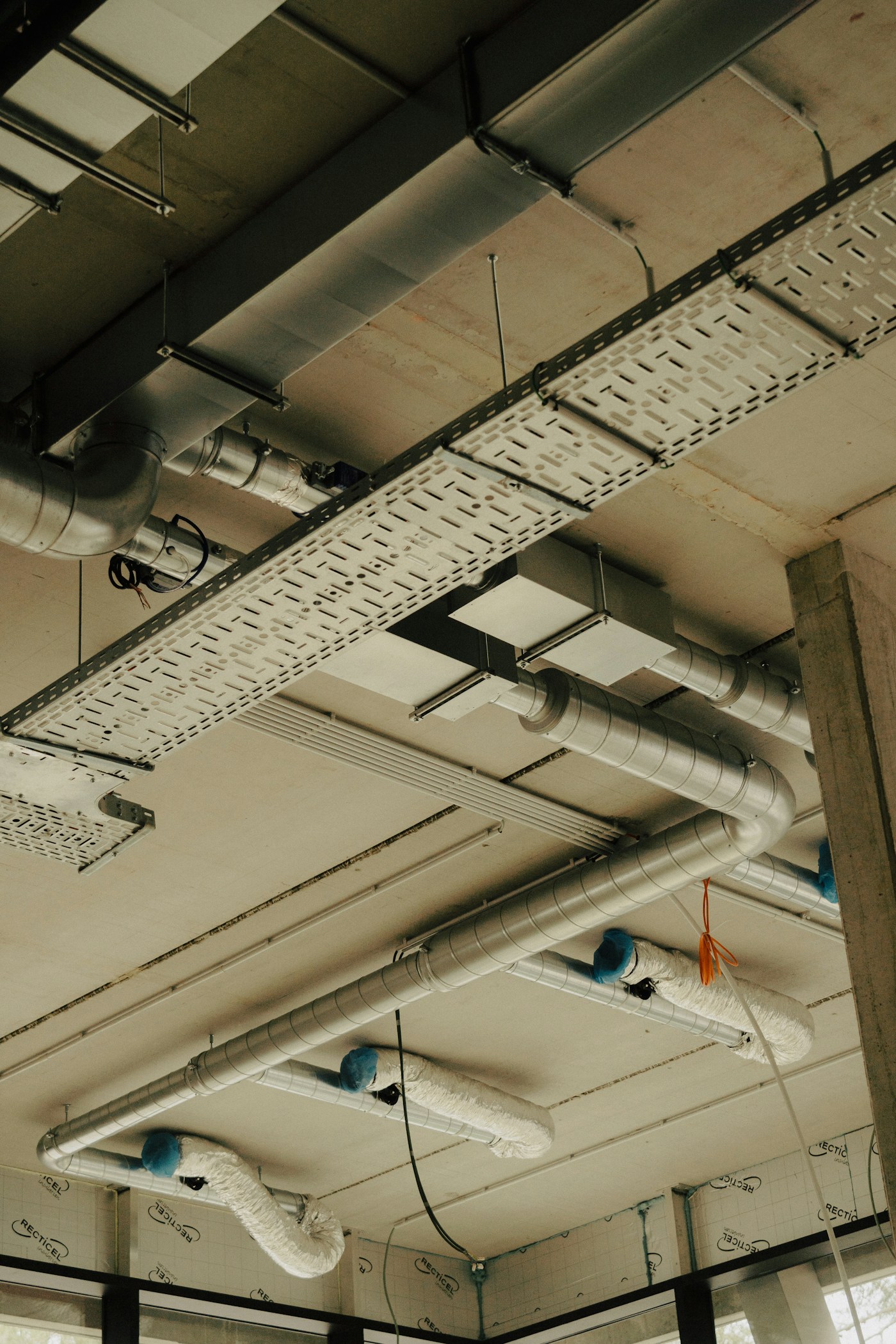 Commercial ceiling with exposed pipes during a Kentwood ceiling repair project