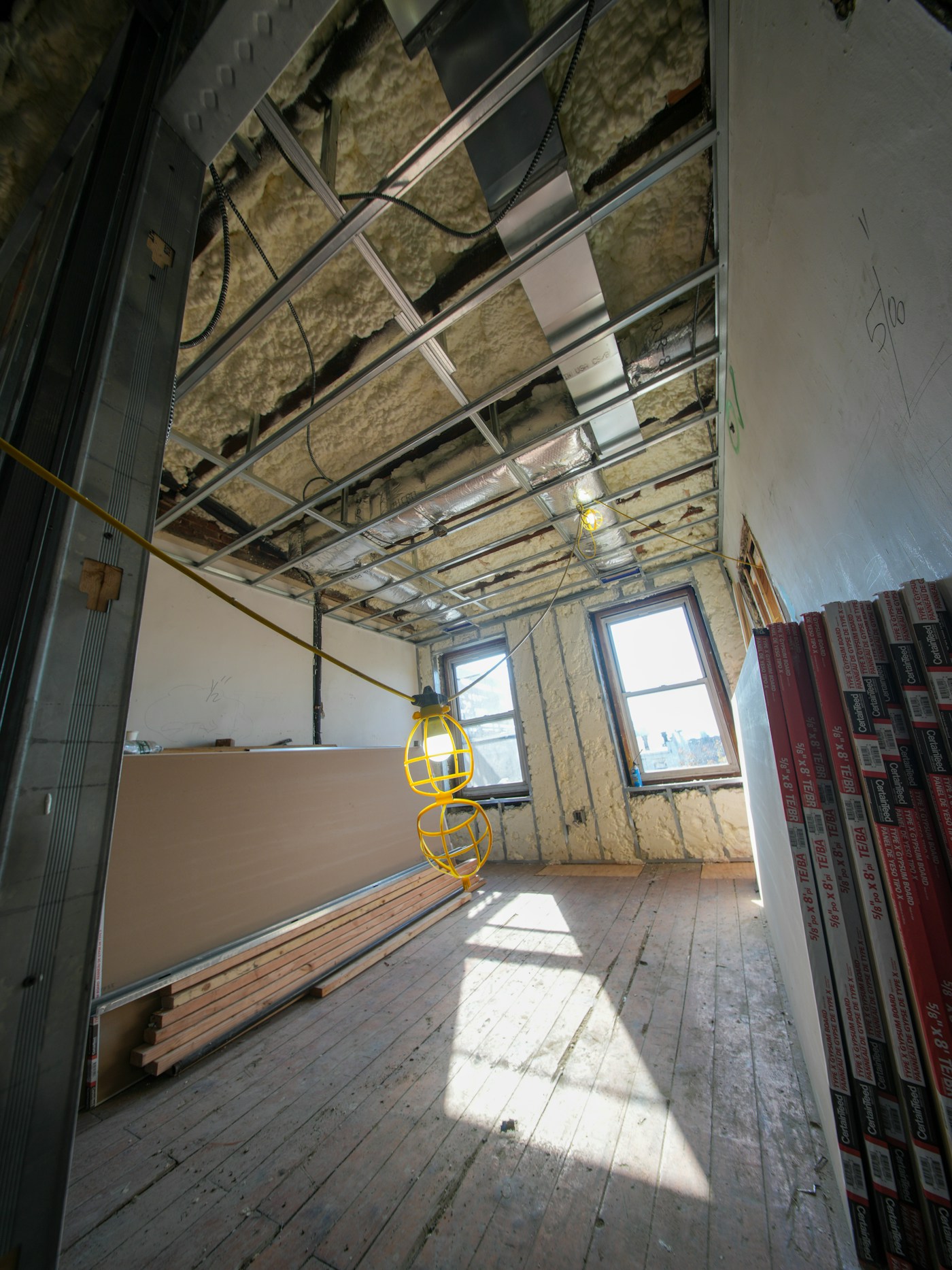 Exposed ceiling framing, ductwork, and drywall ready for ceiling repair