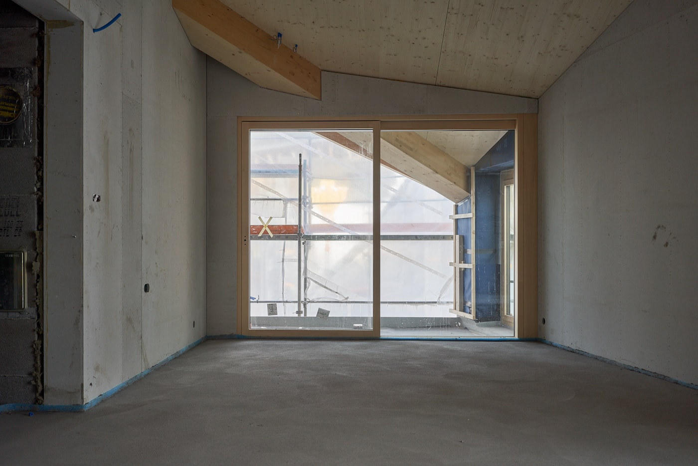 Empty commercial room with sliding glass doors after drywall repair in Grand Rapids