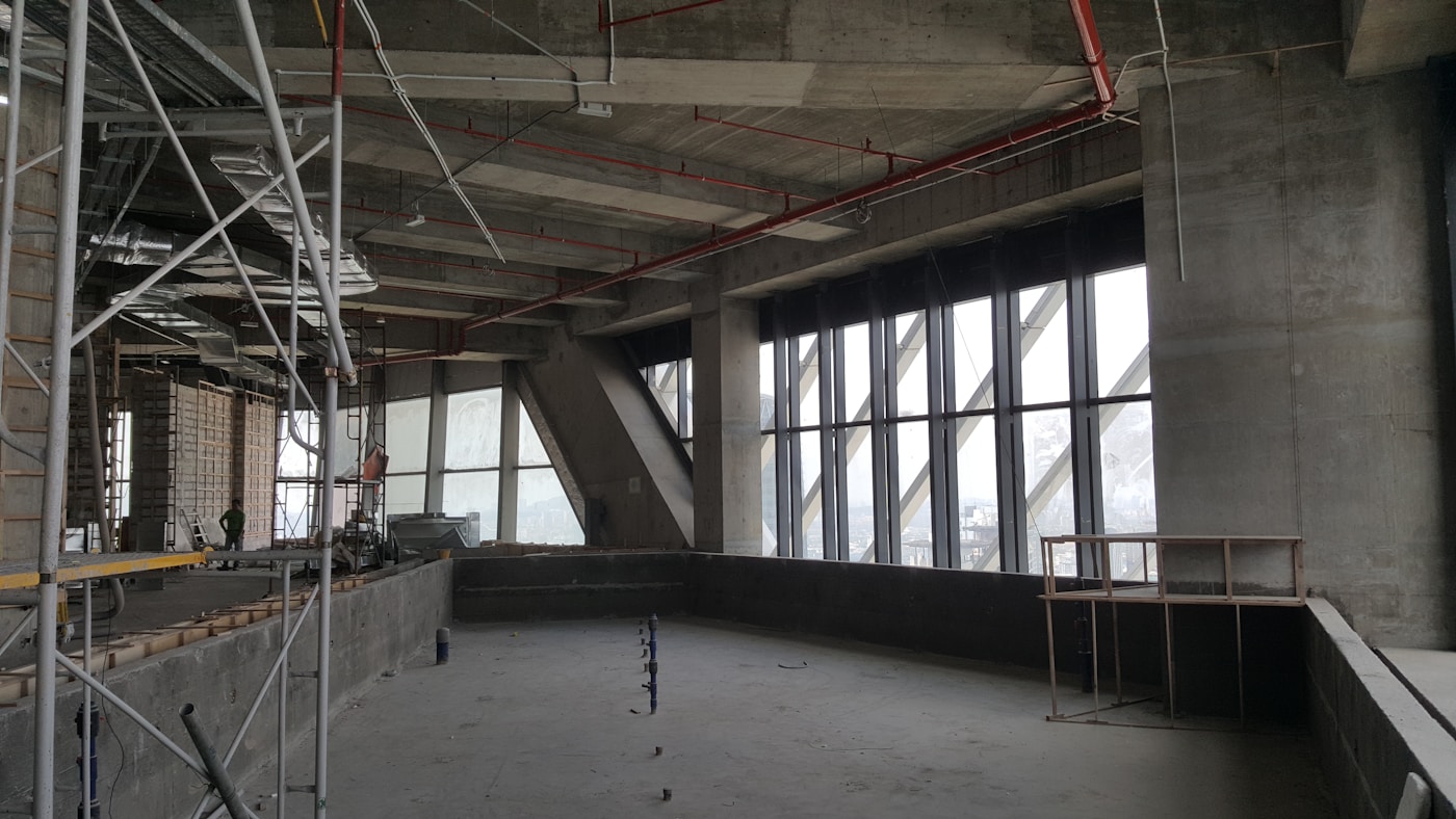 Large commercial room with scaffolding during a Grand Rapids office drywall project