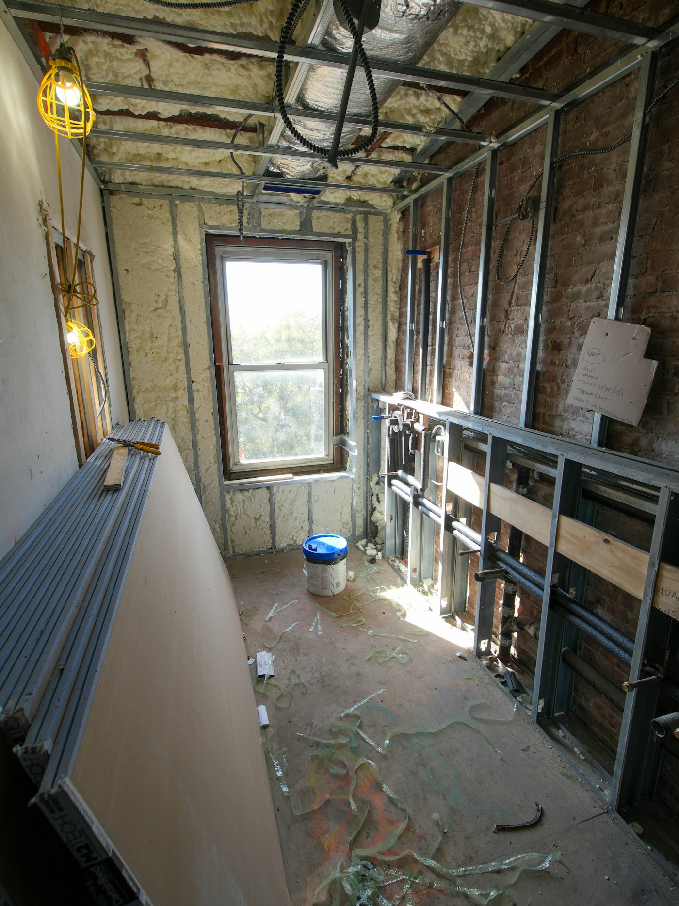Stack of drywall sheets staged for patching and installation